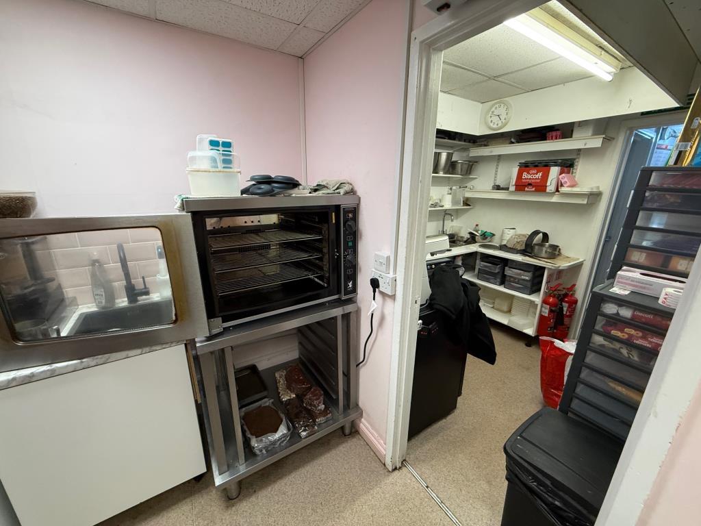 Lot: 78 - TOWN CENTRE COMMERCIAL INVESTMENT - Kitchen and food prep area in the cafe
